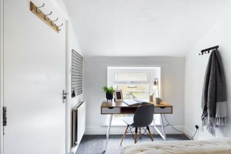 A bright and inviting double bedroom featuring ...