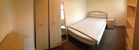 A cozy, well-maintained bedroom with natural li...