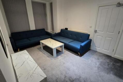 A contemporary and welcoming living room featur...