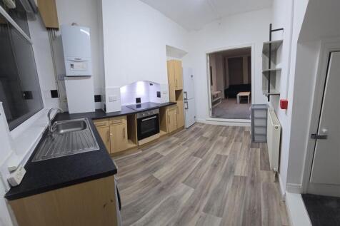 A spacious and modern kitchen area with ample c...