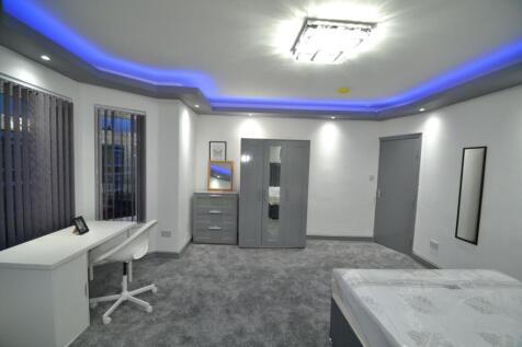 Spacious, modern bedroom with plush grey carpet...