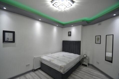 Contemporary double bedroom with a plush uphols...