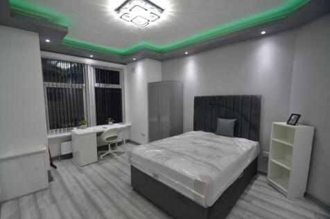 Modern double bedroom with a plush upholstered ...
