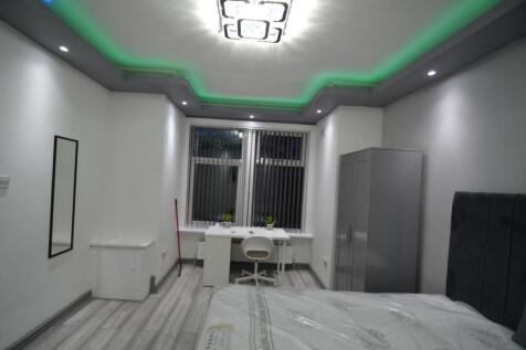 Bright, modern bedroom with stylish ceiling lig...