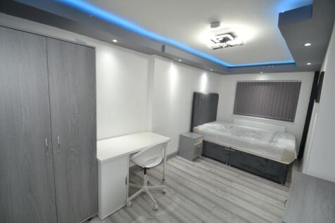 Bright, modern double bedroom with sleek grey t...