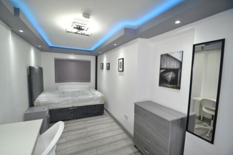 Contemporary furnished bedroom with a double be...