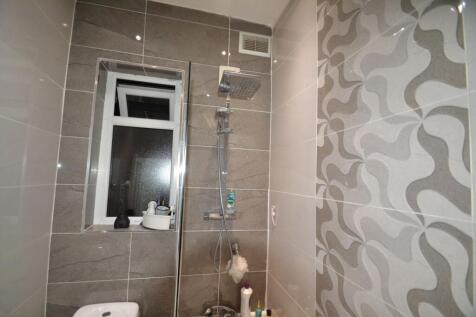 Modern tiled bathroom with a rainfall shower, p...