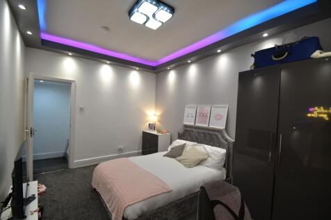 Stylish double bedroom with a plush upholstered...