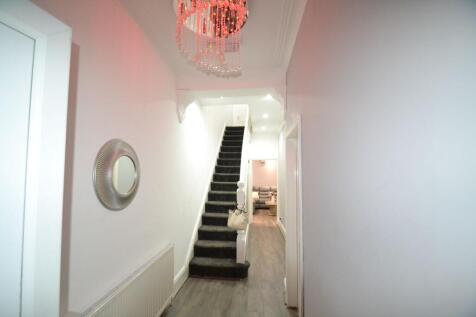 Bright entrance hallway with a central staircas...