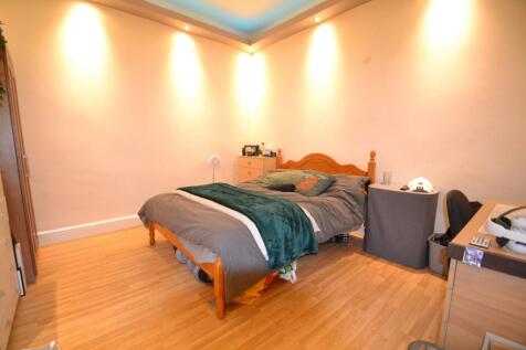 Warm, neatly presented bedroom with wooden bedf...