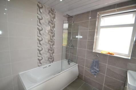 Bright and modern bathroom featuring a large ba...