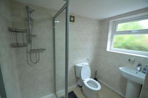 A clean and functional bathroom featuring a sho...