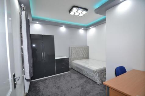 Bright, modern double bedroom with a plush upho...