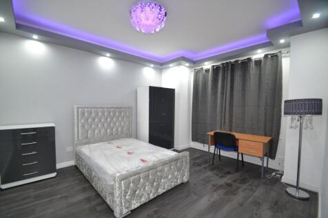 A modern, well-lit bedroom featuring a plush tu...