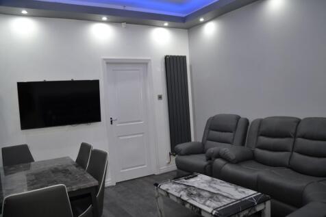 Modern living room featuring a large flat-scree...