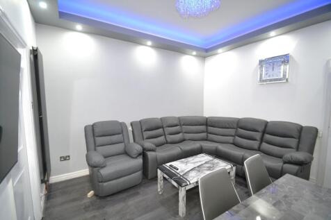 Modern and spacious living room featuring a lar...