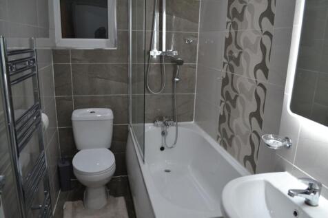 Modern bathroom featuring a combined shower and...