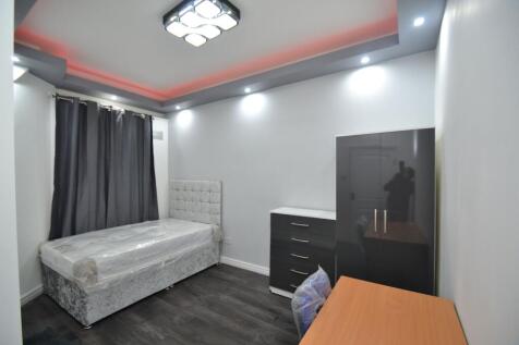 A modern bedroom featuring a comfortable bed wi...