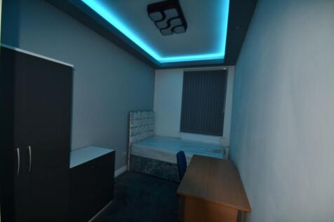 A cozy bedroom featuring a bed, a wardrobe, and...