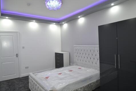 A spacious, modern master bedroom featuring a l...