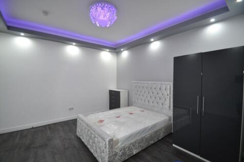 A stylish and spacious master bedroom featuring...