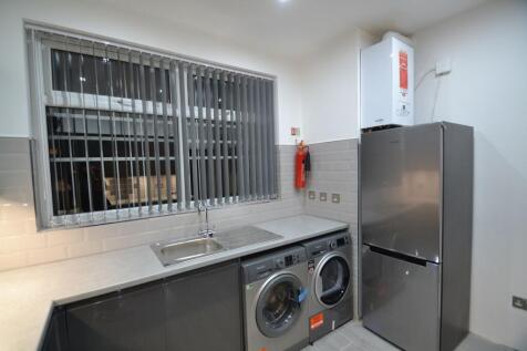 Modern utility-style kitchen with a stainless s...