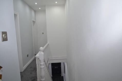 Bright, freshly painted upstairs hallway with r...