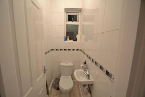 A clean and well-maintained bathroom with white...