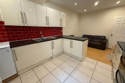 Bright modern kitchen with glossy white cabinet...