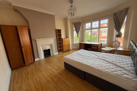 Bright, spacious bedroom with large bay windows...