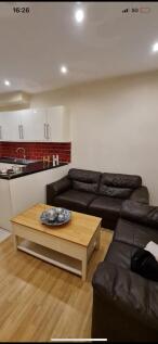 Comfortable living area with two leather sofas,...