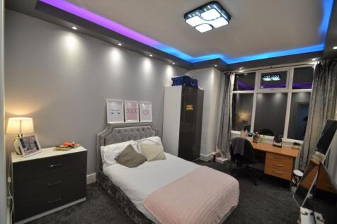 Stylish double bedroom with a plush upholstered...