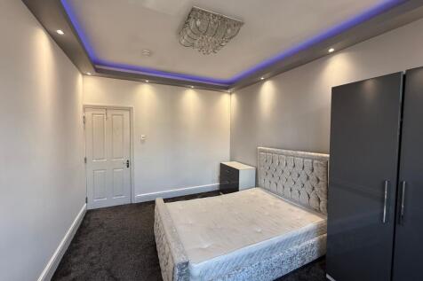 Bright, modern double bedroom with a plush upho...