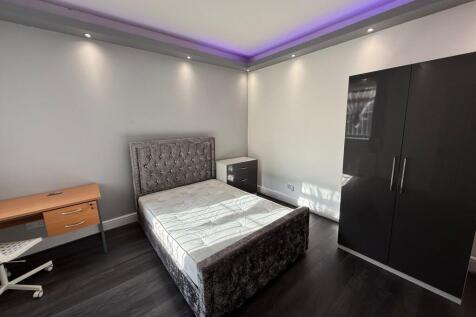 Bright, modern bedroom with a plush upholstered...