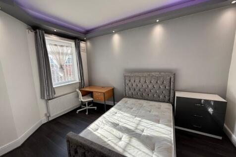 Bright, modern double bedroom with a plush upho...