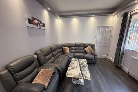 Bright, modern living room with a large L-shape...