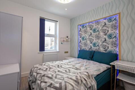 A bright and inviting double bedroom featuring ...