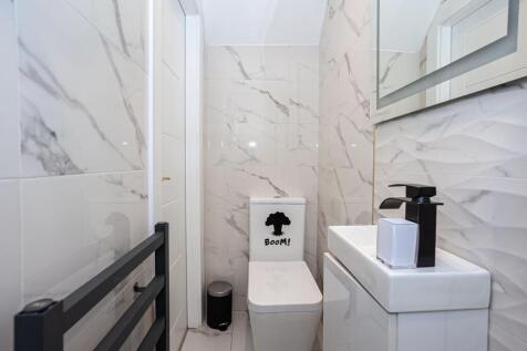 A modern and stylish bathroom featuring elegant...