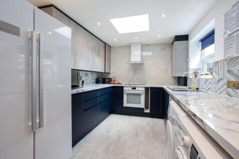 A modern and stylish kitchen with ample counter...