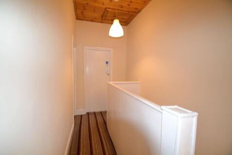A simple, well-maintained hallway with a warm w...