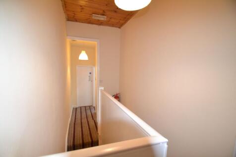 A well-maintained hallway with warm lighting an...