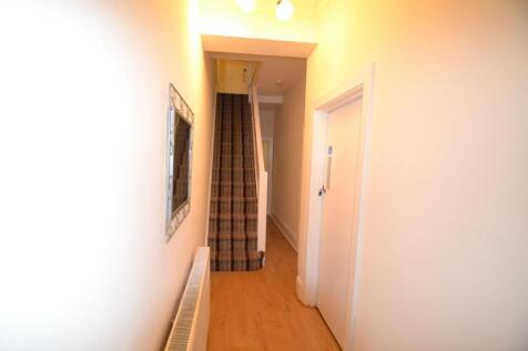Bright, freshly painted hallway with wood-effec...