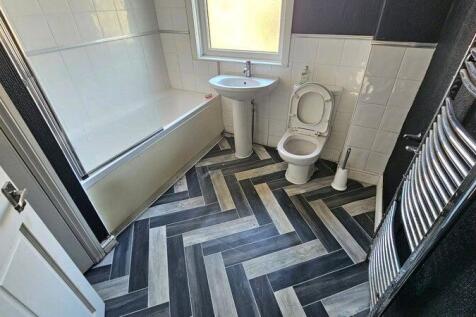 A well-maintained bathroom featuring a large ba...