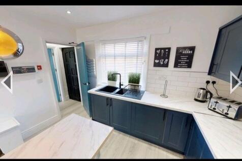 Bright and modern kitchen featuring stylish blu...