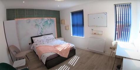 Bright, stylish bedroom with a comfortable doub...