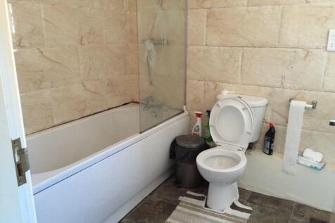 Modern bathroom featuring a spacious bathtub wi...