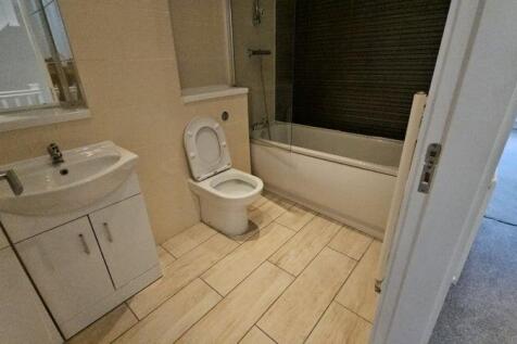 A clean and modern bathroom suite featuring a b...