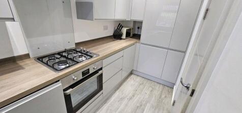 Modern and sleek kitchen with clean white cabin...