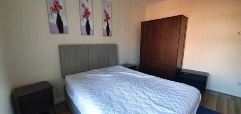 Bright, neatly presented bedroom with a comfort...