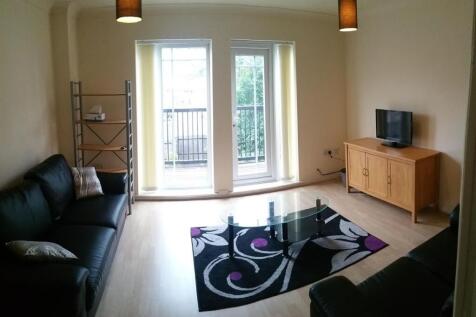 Bright, modern living room with recessed balcon...